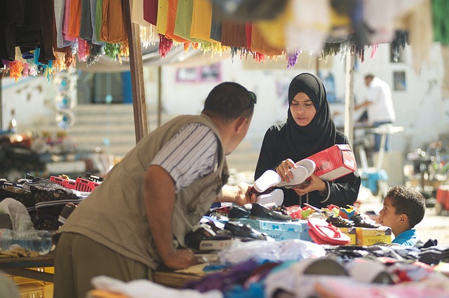 Händler verkauft einer Frau seine Waren.